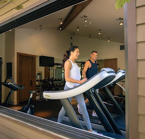 A couple using the treadmills. 
