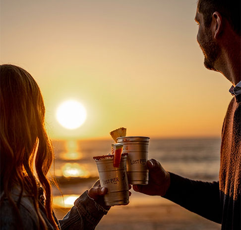 Sunset couple with drinks