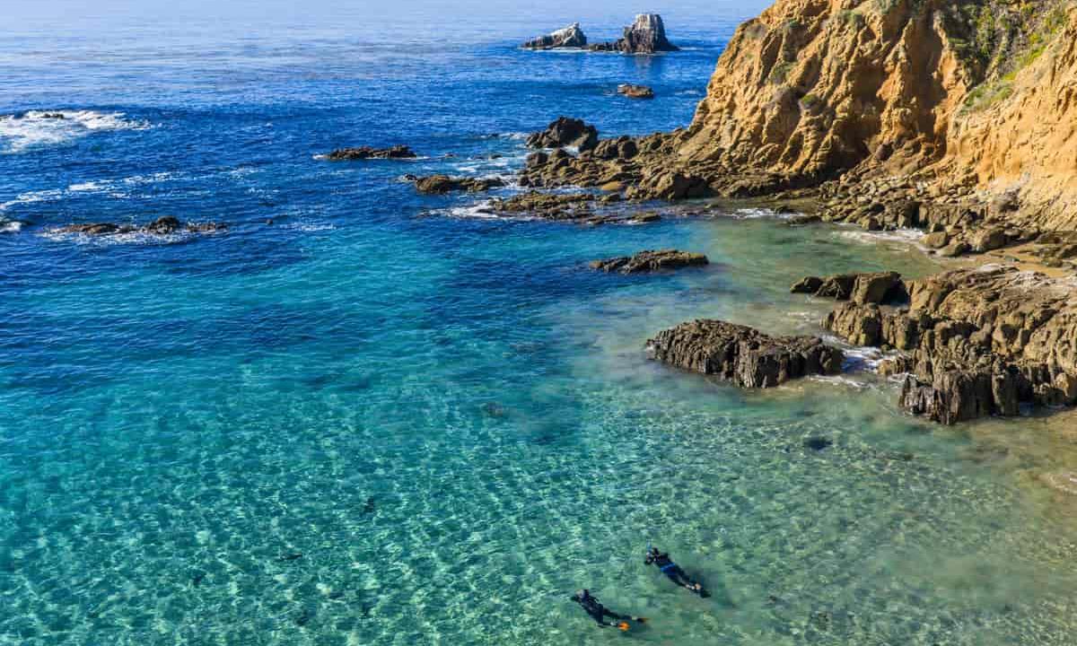 people snorkeling in the cove