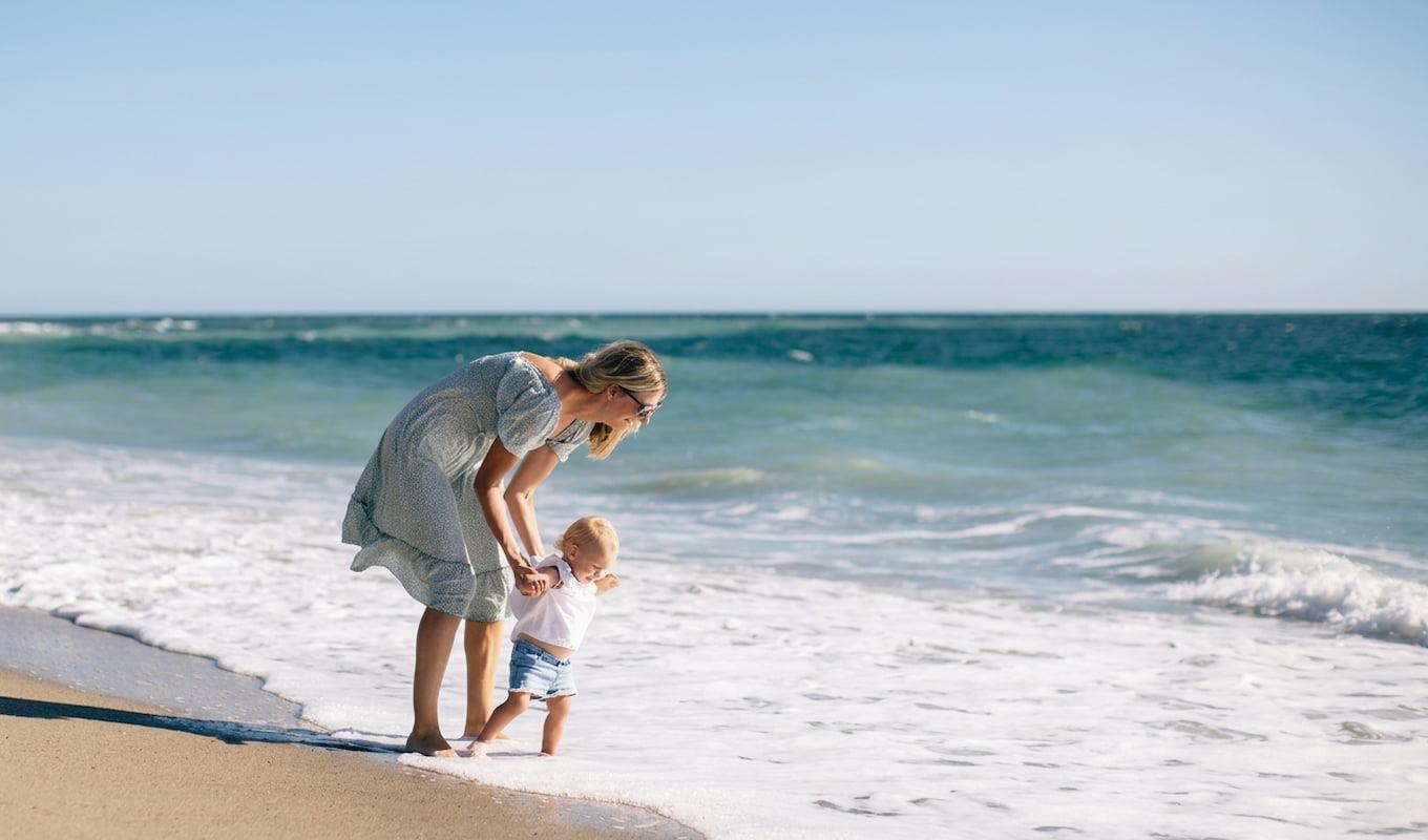 Mother and child playing at the beach