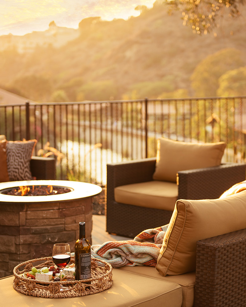 Balcony with fire pit at sunset.
