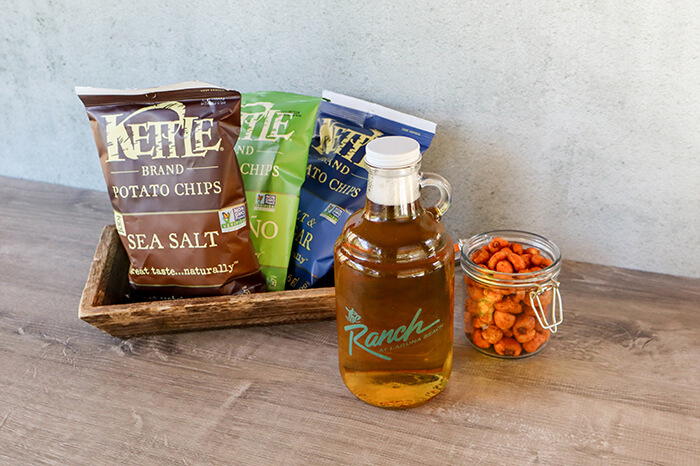 Beer, snacks and corn nuts on a table
