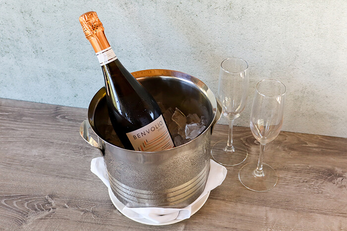Chilled bottle of wine with two glasses on a table