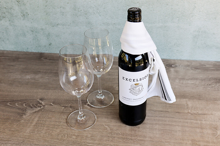 Wine Bottle on table with two glasses