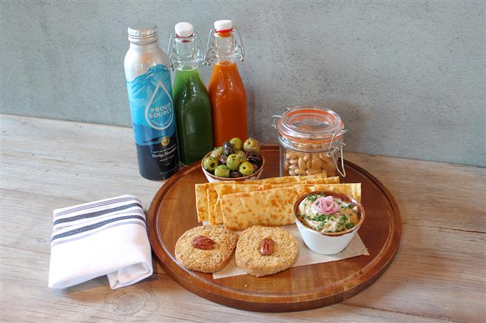 Crackers, hummus, olives and organic juices