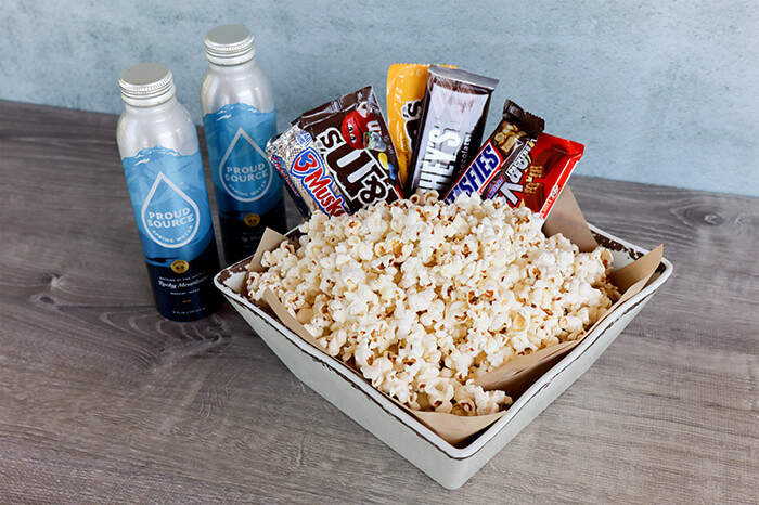 popcorn, candy and water bottles on a table