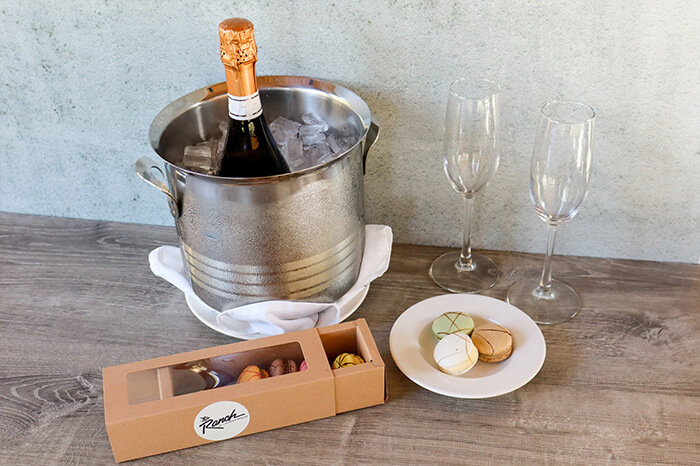 Wine bottles and macarons on a table
