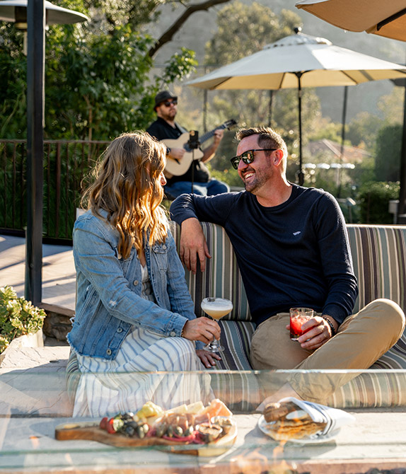 Couple enjoying some drinks by the fire pit. 
