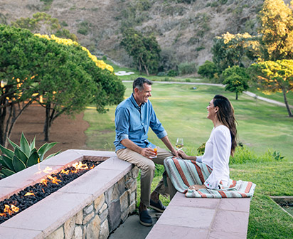 Couple talking by the fire pit. 
